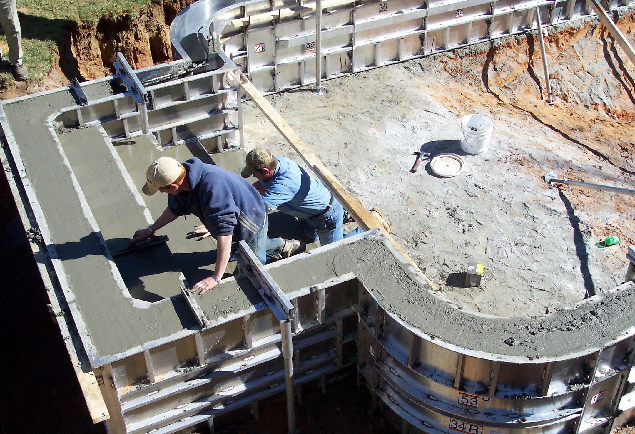 Residential swimming pool installation project with outdoor landscaping